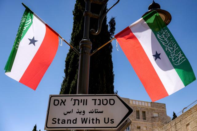 Flags of Somalia's breakaway region of Somaliland fly along a street in western Jerusalem on June 14, 2026. Somaliland's President Abdirahman Mohamed Abdullahi met his Israeli counterpart on June 14 in Jerusalem in his first-ever state visit, which comes months after Israel officially recognised the breakaway African state. In December 2025, Israel became the first country to recognise the independence of Somaliland since it declared its autonomy from Somalia in 1991 following a civil war. (Photo by HAZEM BADER / AFP)