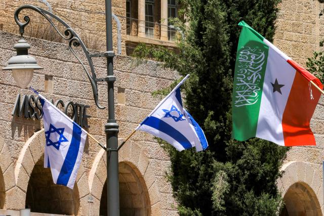 Flags of Somalia's breakaway region of Somaliland fly alongside Israeli flags on a street in western Jerusalem on June 14, 2026. Somaliland's President Abdirahman Mohamed Abdullahi met his Israeli counterpart on June 14 in Jerusalem in his first-ever state visit, which comes months after Israel officially recognised the breakaway African state. In December 2025, Israel became the first country to recognise the independence of Somaliland since it declared its autonomy from Somalia in 1991 following a civil war. (Photo by HAZEM BADER / AFP)