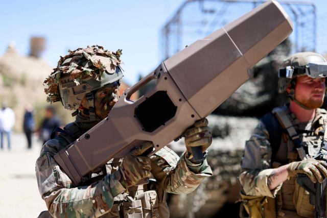 A soldier carries a portable NEROD F5 anti-drone jammer during a dynamic demonstration of military equipment at the Eurosatory defence and security trade show at the Paris Nord Villepinte Exhibition Centre in Villepinte, a northeastern suburb of Paris, on June 14, 2026. The Eurosatory trade show takes place from June 15 to 19, 2026. (Photo by Kenzo TRIBOUILLARD / AFP)