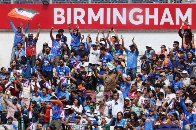 India supporters cheer at the start of the ICC Women's T20 cricket World Cup 2026 Group A stage, Match 6 match between the India and Pakistan at Edgbaston cricket ground in Birmingham, central England on June 14, 2026. (Photo by Darren Staples / AFP)