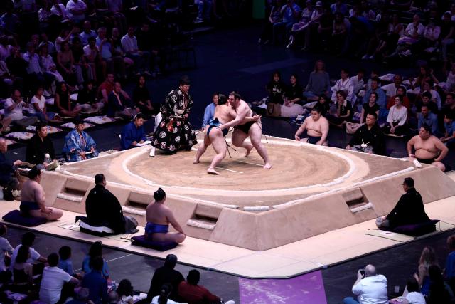 Ukrainian sumo wrestler Shishi (L) battles with Japanese sumo wrestler Kotoeiho during their bout on day 2 of the 2026 Paris Sumo Tournament, in Paris on June 14, 2026. (Photo by Behrouz MEHRI / AFP)