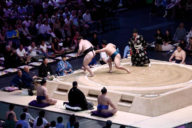 Ukrainian sumo wrestler Shishi (L) battles with Japanese sumo wrestler Kotoeiho during their bout on day 2 of the 2026 Paris Sumo Tournament, in Paris on June 14, 2026. (Photo by Behrouz MEHRI / AFP)