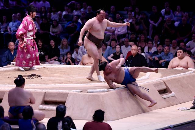 Mongolian sumo wrestler Chiyosh?ma (L) wins over Japanese sumo wrestler Fujinokawa during their bout on day 2 of the 2026 Paris Sumo Tournament, in Paris on June 14, 2026. (Photo by Behrouz MEHRI / AFP)