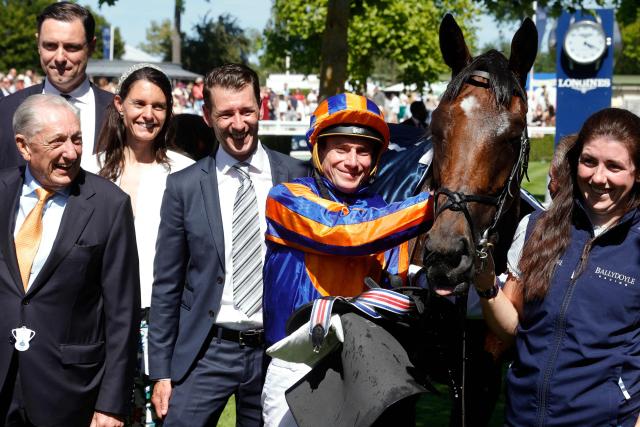 English jockey Ryan Moore (C) celebrates after victory on 'Diamond Necklace' at the 177th Prix de Diane horse race in Chantilly, north of Paris on June 14, 2026. (Photo by GEOFFROY VAN DER HASSELT / AFP)