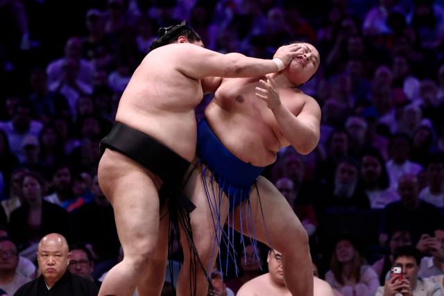Japanese sumo wrestler Abi (L) battles with Japanese sumo wrestler Kotoshoho during their bout on day 2 of the 2026 Paris Sumo Tournament, in Paris on June 14, 2026. (Photo by Behrouz MEHRI / AFP)