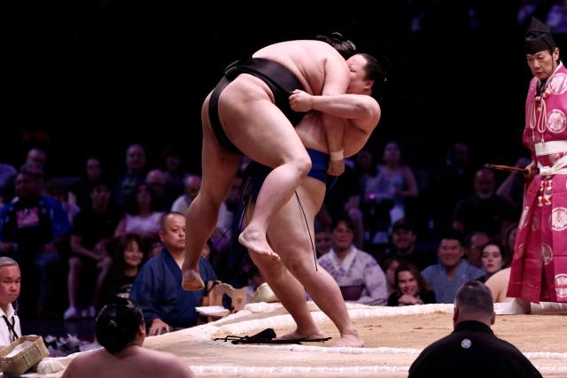 Japanese sumo wrestler Abi (L) battles with Japanese sumo wrestler Kotoshoho during their bout on day 2 of the 2026 Paris Sumo Tournament, in Paris on June 14, 2026. (Photo by Behrouz MEHRI / AFP)