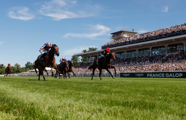 English jockey Ryan Moore (L) rides 'Diamond Necklace' to victory alongside second placed French jockey Tony Piccone on 'Pink Panthera' at the 177th Prix de Diane horse race in Chantilly, north of Paris on June 14, 2026. (Photo by GEOFFROY VAN DER HASSELT / AFP)