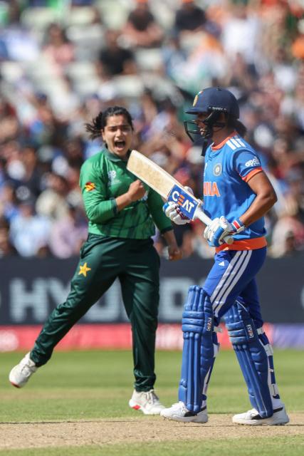 Pakistan's captain Fatima Sana (L) celebrates after dismissing India's captain Harmanpreet Kaur (R) during the ICC Women's T20 cricket World Cup 2026 Group A stage, Match 6 match between the India and Pakistan at Edgbaston cricket ground in Birmingham, central England on June 14, 2026. (Photo by Darren Staples / AFP)