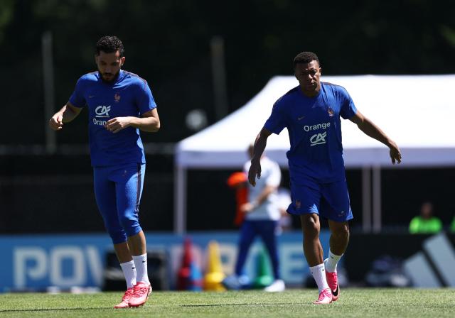 France's forwards #24 Rayan Cherki (L) and #10 Kylian Mbappe jog during a training session at Bentley University, the team's base camp, during the 2026 World Cup football tournament in Waltham, near Boston, on June 14, 2026. (Photo by FRANCK FIFE / AFP)