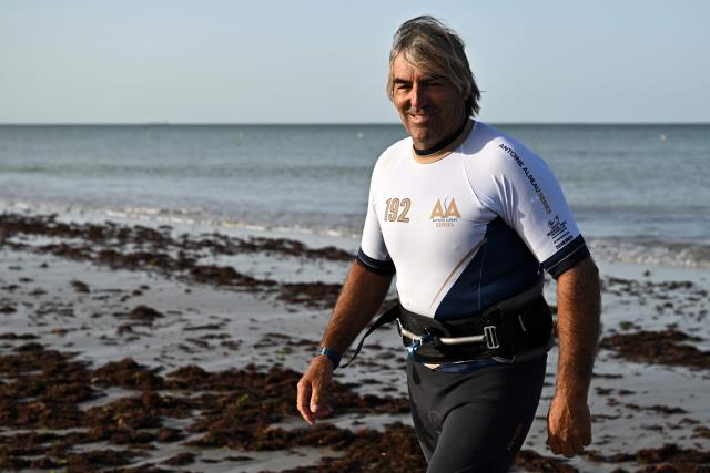 French windsurfer and 27-times world champion Antoine Albeau looks on as he walks on the beach ahead of the start of the 4th edition of the Antoine Albeau Series off La Couarde-sur-Mer on the Ré island, southwestern France on June 14, 2026. (Photo by Christophe ARCHAMBAULT / AFP)