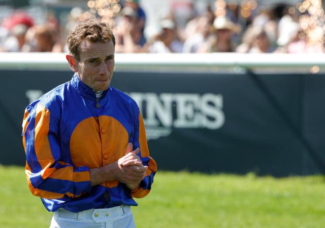English jockey Ryan-Lee Moore gestures as he celebrates after victory on 'Diamond Necklace' at the 177th Prix de Diane horse race in Chantilly, north of Paris on June 14, 2026. (Photo by GEOFFROY VAN DER HASSELT / AFP)