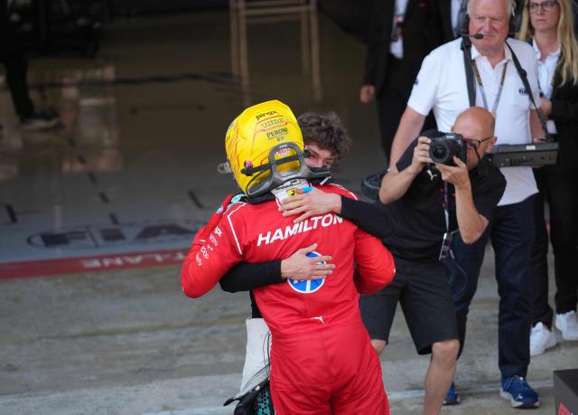 Ferrari's British driver Lewis Hamilton is hugged by Mercedes' Italian driver Kimi Antonelli after winning the Catalonia Formula One Grand Prix at the Circuit de Catalunya in Montmelo, on the outskirts of Barcelona, on June 14, 2026. (Photo by Manaure QUINTERO / AFP)