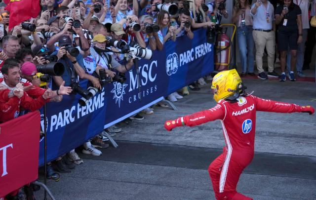 Ferrari's British driver Lewis Hamilton celebrates with his team after winning the Catalonia Formula One Grand Prix at the Circuit de Catalunya in Montmelo, on the outskirts of Barcelona, on June 14, 2026. (Photo by Manaure QUINTERO / AFP)