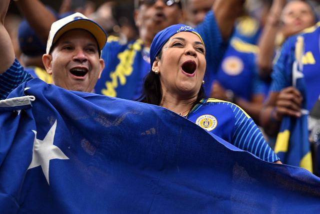 Curacao supporters cheer ahead of the 2026 World Cup Group E football match between Germany and Curacao at the Houston Stadium in Houston on June 14, 2026.  (Photo by Paul ELLIS / AFP)