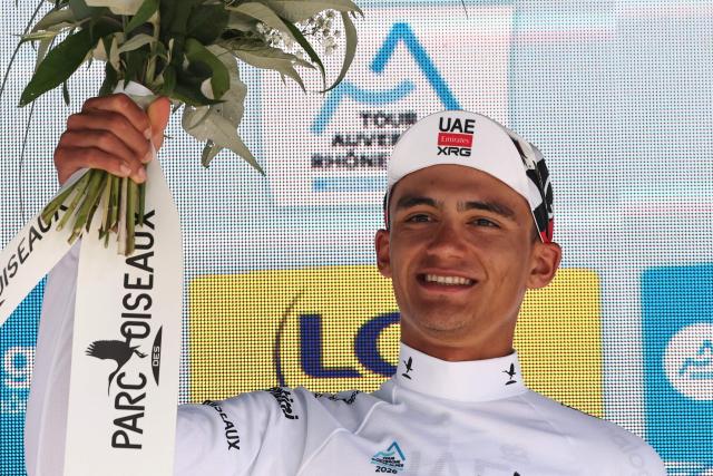 UAE Team Emirates XRG's Mexican rider Isaac Del Toro Romero celebrates on the podium wearing the best young rider's white jersey after winning the 8th and final stage of the Tour Auvergne-Rhone-Alpes cycling race (formerly known as the Criterium du Dauphine), 120,1km between Beaufort and Plateau de Solaison, in the French Alps on June 14, 2026. (Photo by Anne-Christine POUJOULAT / AFP)