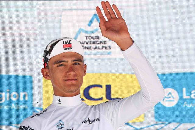 UAE Team Emirates XRG's Mexican rider Isaac Del Toro Romero celebrates on the podium wearing the best young rider's white jersey after winning the 8th and final stage of the Tour Auvergne-Rhone-Alpes cycling race (formerly known as the Criterium du Dauphine), 120,1km between Beaufort and Plateau de Solaison, in the French Alps on June 14, 2026. (Photo by Anne-Christine POUJOULAT / AFP)