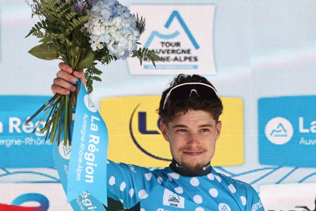 Groupama-FDJ United's French rider Clément Braz Afonso celebrates on the podium wearing the climber's dotted jersey after the 8th and final stage of the Tour Auvergne-Rhone-Alpes cycling race (formerly known as the Criterium du Dauphine), 120,1km between Beaufort and Plateau de Solaison, in the French Alps on June 14, 2026. (Photo by Anne-Christine POUJOULAT / AFP)