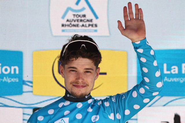 Groupama-FDJ United's French rider Clément Braz Afonso celebrates on the podium wearing the climber's dotted jersey after the 8th and final stage of the Tour Auvergne-Rhone-Alpes cycling race (formerly known as the Criterium du Dauphine), 120,1km between Beaufort and Plateau de Solaison, in the French Alps on June 14, 2026. (Photo by Anne-Christine POUJOULAT / AFP)