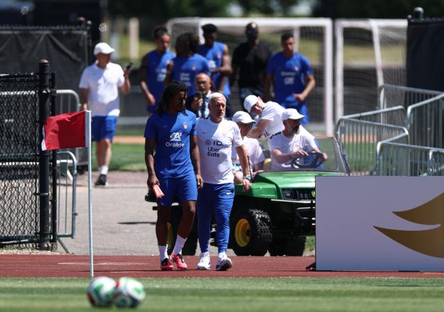 France's head coach Didier Deschamps and defender #05 Jules Kounde arrive for a training session at Bentley University, the team's base camp, during the 2026 World Cup football tournament in Waltham, near Boston, on June 14, 2026. (Photo by FRANCK FIFE / AFP)