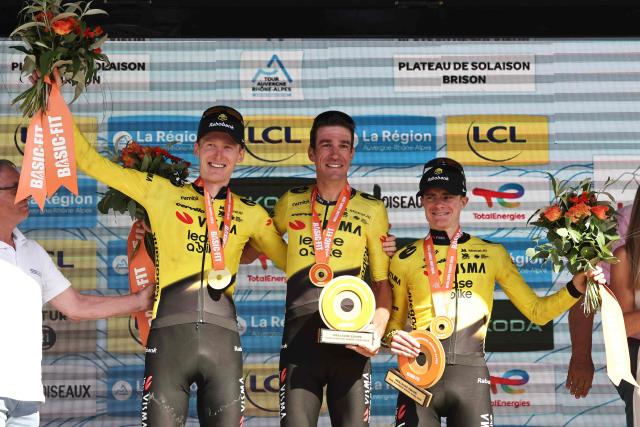 (From L) Team Visma - Lease a bike team's US rider Matteo Jorgenson, Team Visma | Lease a Bike's French rider Bruno Armirail and Team Visma | Lease a Bike's British rider Ben Tulett celebrate winning the best team award on the podium after the 8th and final stage of the Tour Auvergne-Rhone-Alpes cycling race (formerly known as the Criterium du Dauphine), 120,1km between Beaufort and Plateau de Solaison, in the French Alps on June 14, 2026. (Photo by Anne-Christine POUJOULAT / AFP)