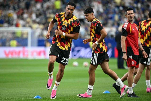 Germany's midfielder #23 Felix Nmecha (L) and Germany's midfielder #05 Aleksandar Pavlovic (R) take part in the warm-up ahead of the 2026 World Cup Group E football match between Germany and Curacao at the Houston Stadium in Houston on June 14, 2026.  (Photo by Paul ELLIS / AFP)