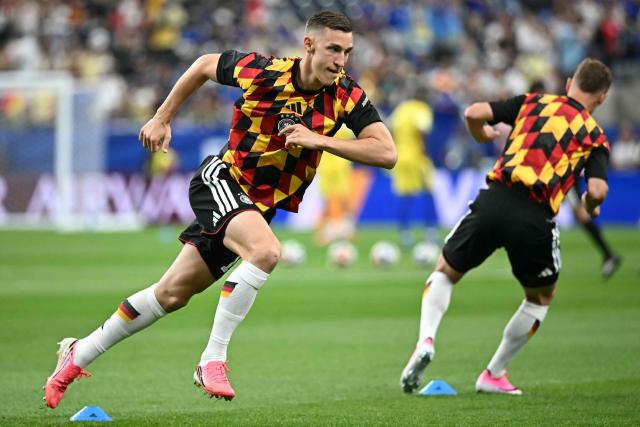 Germany's defender #15 Nico Schlotterbeck takes part in the warm-up ahead of the 2026 World Cup Group E football match between Germany and Curacao at the Houston Stadium in Houston on June 14, 2026.  (Photo by Paul ELLIS / AFP)