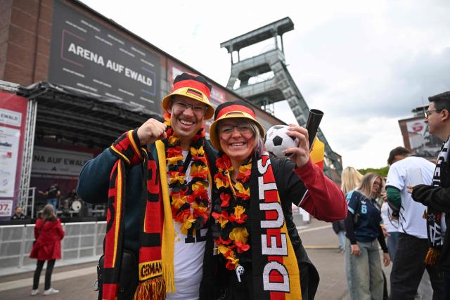 German fans arrive for the public screening of Germany's opening match at the 2026 World Cup against Curacao at the former coal mine 'Ewald' in Herten, western Germany on June 14, 2026. (Photo by INA FASSBENDER / AFP)