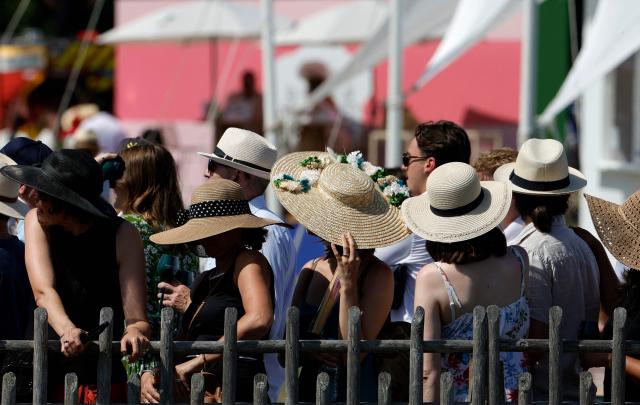 Racegoers look on ahead of the 177th Prix de Diane horse race in Chantilly, north of Paris on June 14, 2026. (Photo by GEOFFROY VAN DER HASSELT / AFP)