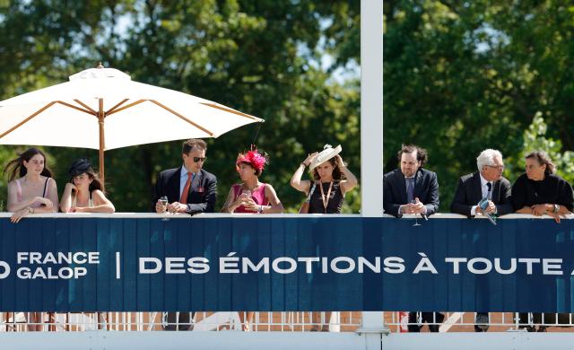 Racegoers look on ahead of the 177th Prix de Diane horse race in Chantilly, north of Paris on June 14, 2026. (Photo by GEOFFROY VAN DER HASSELT / AFP)