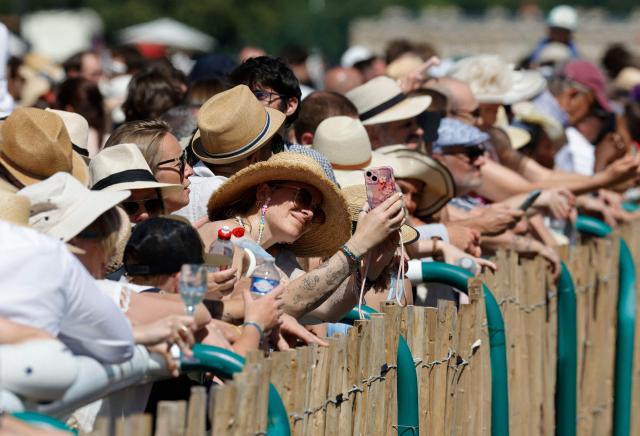 Racegoers look on ahead of the 177th Prix de Diane horse race in Chantilly, north of Paris on June 14, 2026. (Photo by GEOFFROY VAN DER HASSELT / AFP)