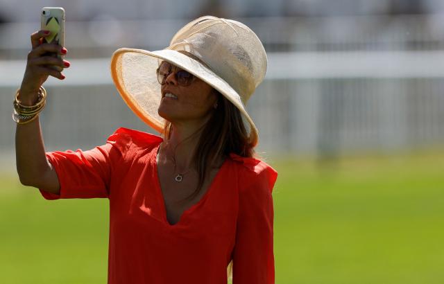 A racegoer takes a 'selfie' ahead of the 177th Prix de Diane horse race in Chantilly, north of Paris on June 14, 2026. (Photo by GEOFFROY VAN DER HASSELT / AFP)