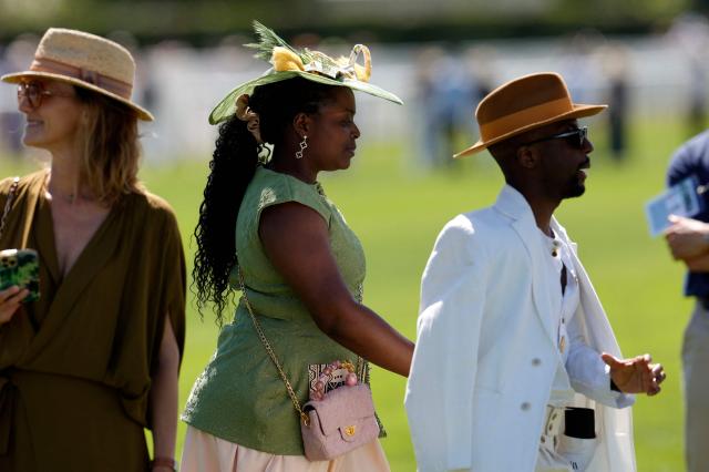 Racegoers walk ahead of the 177th Prix de Diane horse race in Chantilly, north of Paris on June 14, 2026. (Photo by GEOFFROY VAN DER HASSELT / AFP)