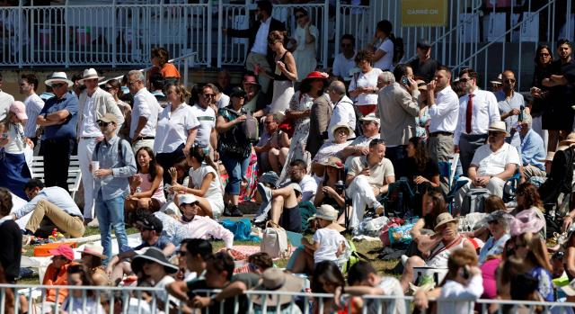 Racegoers look on ahead of the 177th Prix de Diane horse race in Chantilly, north of Paris on June 14, 2026. (Photo by GEOFFROY VAN DER HASSELT / AFP)