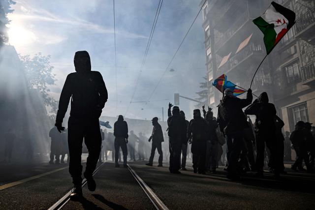 Demonstrators take part in a rally of a "No-G7" coalition of over 60 associations, unions and left-wing groups "against fascism and imperialism”, a day ahead of the summit's start, in Geneva on June 14, 2026. The 2026 edition of the G7 summit is set to take place June 15 to 17 in the French town of Evian-les-Bains near Switzerland, attended by country leaders as well as the EU's foreign policy chief and ministers from Brazil, Canada, the United Arab Emirates and Turkey. (Photo by Gabriel Monnet / AFP)