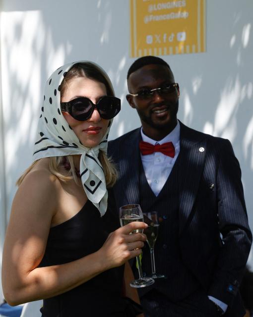 Racegoers pose ahead of the 177th Prix de Diane horse race in Chantilly, north of Paris on June 14, 2026. (Photo by GEOFFROY VAN DER HASSELT / AFP)
