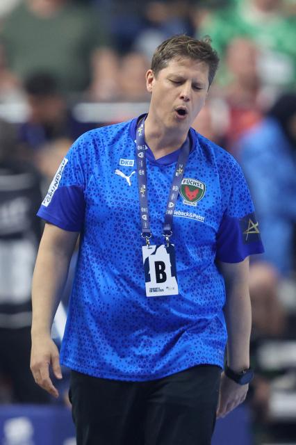 Fuechse Berlin's Danish head coach Nicolej Krickau reacts from the sidelines during the EHF Men's Handball Champions League Final 4 final between Barca and Fuechse Berlin in Cologne, western Germany on June 14, 2026. (Photo by Ronny HARTMANN / AFP)
