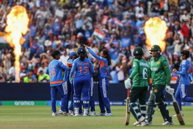 India (in blue) celebrate their victory at the end of the ICC Women's T20 cricket World Cup 2026 Group A stage, Match 6 match between the India and Pakistan at Edgbaston cricket ground in Birmingham, central England on June 14, 2026. (Photo by Darren Staples / AFP)