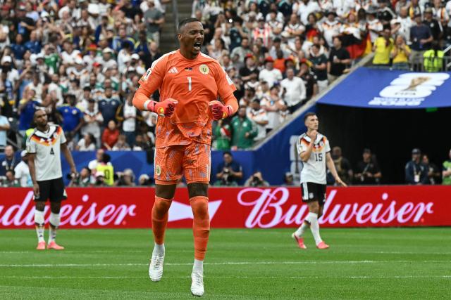 Curacao's goalkeeper #01 Eloy Room celebrates his team's first goal  during the 2026 World Cup Group E football match between Germany and Curacao at the Houston Stadium in Houston on June 14, 2026.  (Photo by RONALDO SCHEMIDT / AFP)