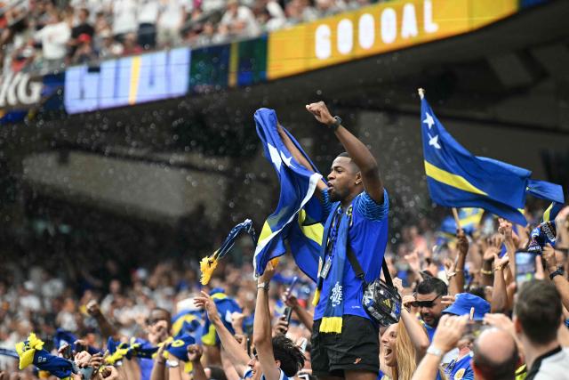 Curacao supporters celebrate thei team scoring their first goal  during the 2026 World Cup Group E football match between Germany and Curacao at the Houston Stadium in Houston on June 14, 2026.  (Photo by RONALDO SCHEMIDT / AFP)
