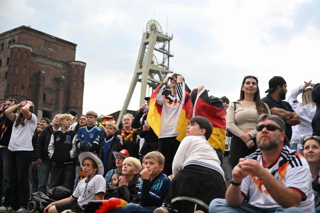 Germany fans react after the 1-1 goal at the public screening of Germany's opening match at the 2026 World Cup against Curacao at the former coal mine 'Ewald' in Herten, western Germany on June 14, 2026. (Photo by INA FASSBENDER / AFP)