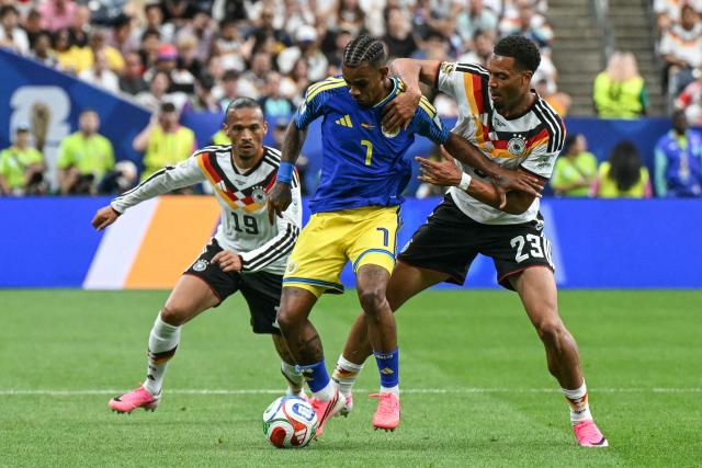 Curacao's midfielder #07 Juninho Bacuna (C) fights for the ball with Germany's defender #23 Felix Nmecha (R) and Germany's forward #19 Leroy Sane (L)  during the 2026 World Cup Group E football match between Germany and Curacao at the Houston Stadium in Houston on June 14, 2026.  (Photo by RONALDO SCHEMIDT / AFP)