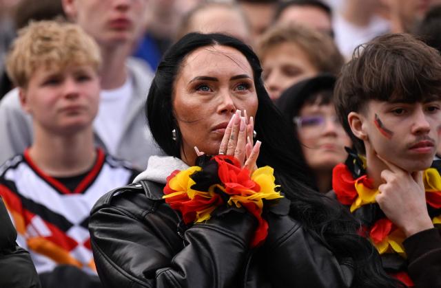 Germany fans react after the 1-1 goal at the public screening of Germany's opening match at the 2026 World Cup against Curacao at the former coal mine 'Ewald' in Herten, western Germany on June 14, 2026. (Photo by INA FASSBENDER / AFP)