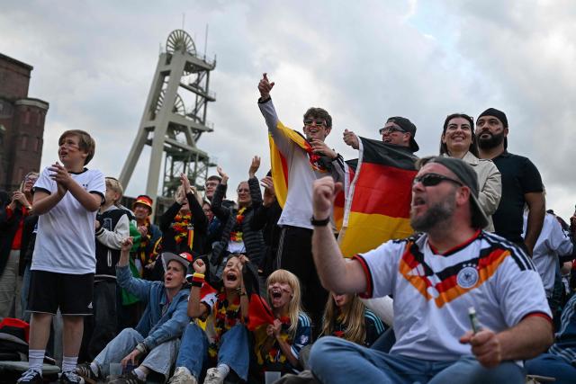 Germany fans celebrate the 2-1 goal at the public screening of Germany's opening match at the 2026 World Cup against Curacao at the former coal mine 'Ewald' in Herten, western Germany on June 14, 2026. (Photo by INA FASSBENDER / AFP)
