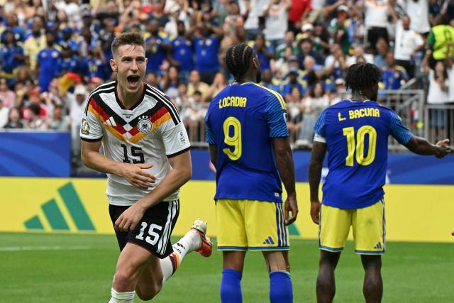 Germany's defender #15 Nico Schlotterbeck (L) celebrates after scoring his team's second goal during the 2026 World Cup Group E football match between Germany and Curacao at the Houston Stadium in Houston on June 14, 2026.  (Photo by RONALDO SCHEMIDT / AFP)