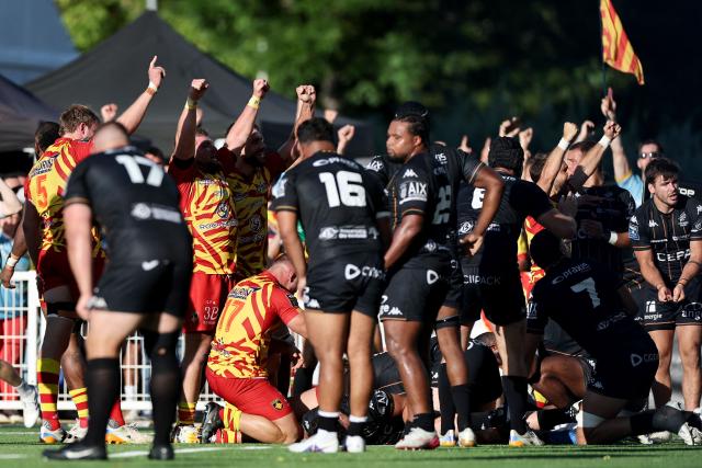 Perpignan's players celebrate after Perpignan's Argentine hooker Ignacio Ruiz scored a try during the French Top14 / ProD2 rugby union access-match for the 2026/27 season between Provence Rugby and Perpignan at the Maurice-David stadium in Aix-en-Provence, near Marseille, on June 14, 2026. (Photo by Thibaud MORITZ / AFP)