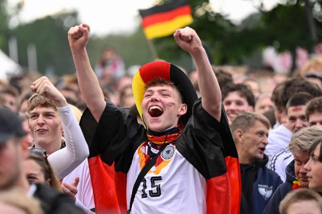 Germany fans celebrate the 2-1 goal at the public screening of Germany's opening match at the 2026 World Cup against Curacao at the former coal mine 'Ewald' in Herten, western Germany on June 14, 2026. (Photo by INA FASSBENDER / AFP)