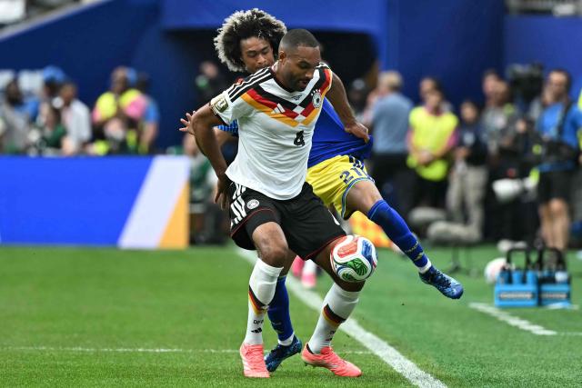 Germany's defender #04 Jonathan Tah (front) fights for the ball with Curacao's midfielder #21 Tahith Chong during the 2026 World Cup Group E football match between Germany and Curacao at the Houston Stadium in Houston on June 14, 2026.  (Photo by Paul ELLIS / AFP)