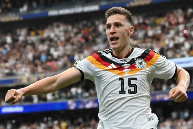 Germany's defender #15 Nico Schlotterbeck celebrates after scoring his team's second goal during the 2026 World Cup Group E football match between Germany and Curacao at the Houston Stadium in Houston on June 14, 2026.  (Photo by RONALDO SCHEMIDT / AFP)