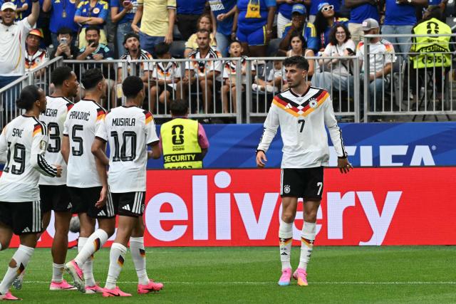Germany's forward #07 Kai Havertz (R) celebrates with teammates after scoring a penalty kick for his team's third goal during the 2026 World Cup Group E football match between Germany and Curacao at the Houston Stadium in Houston on June 14, 2026.  (Photo by RONALDO SCHEMIDT / AFP)