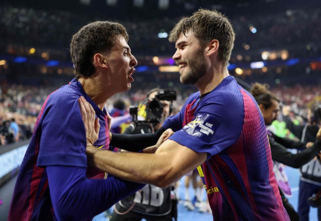 FC Barcelona's Spanish left wing #83 Ian Barrufet and FC Barcelona's Bosnian-born right back #11 Djordje Cikusa celebrate after winning the EHF Men's Handball Champions League Final 4 final between Barca and Fuechse Berlin in Cologne, western Germany on June 14, 2026. Barca won the match 37:34. (Photo by Ronny HARTMANN / AFP)